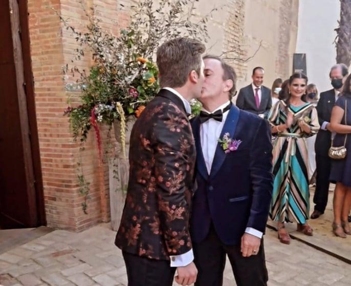 Enrique and David in front of a church after being married.